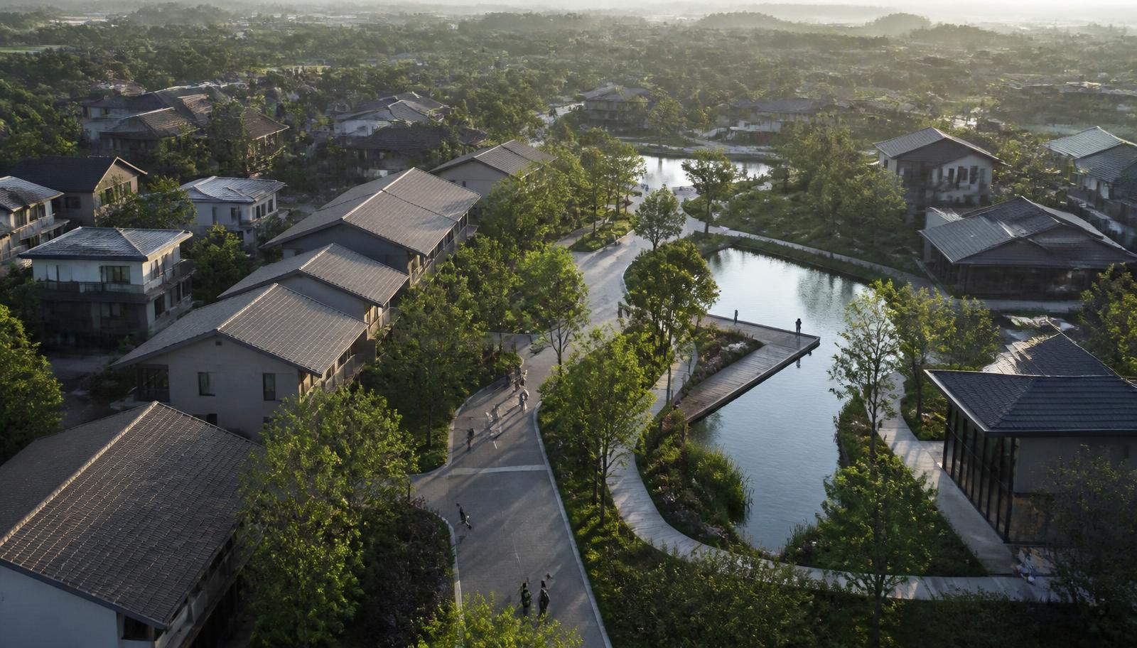 Aerial view of a walkable neighbourhood with green corridors and water at morning light